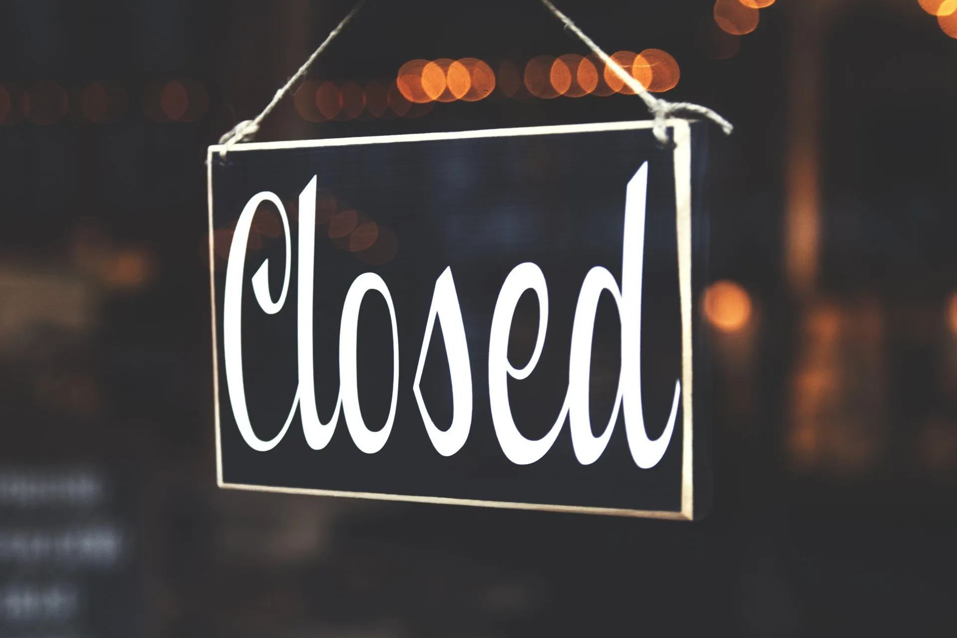 Closed sign hanging in a window
